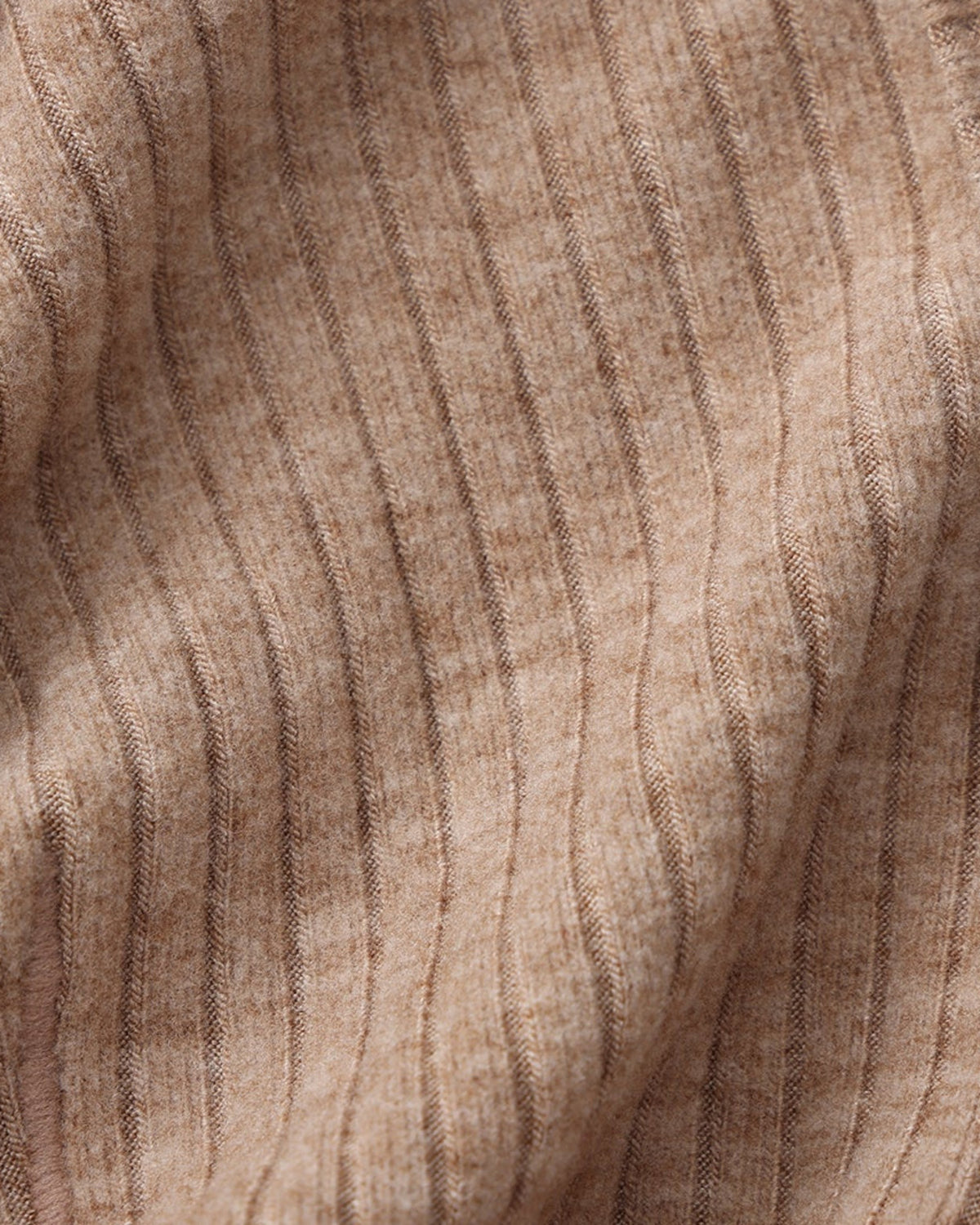 Close-up of the brown ribbed stretch fabric and seam texture