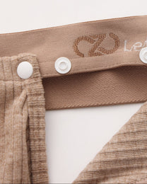 Close-up of the brown snap connection and BSZN logo waistband