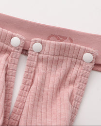 Close-up of the pink snap connection and BSZN logo waistband