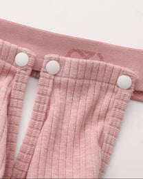 Close-up of the pink snap connection and BSZN logo waistband