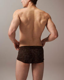 Model wearing the mottled brown BSZN slash-cut trunk, full-coverage rear view